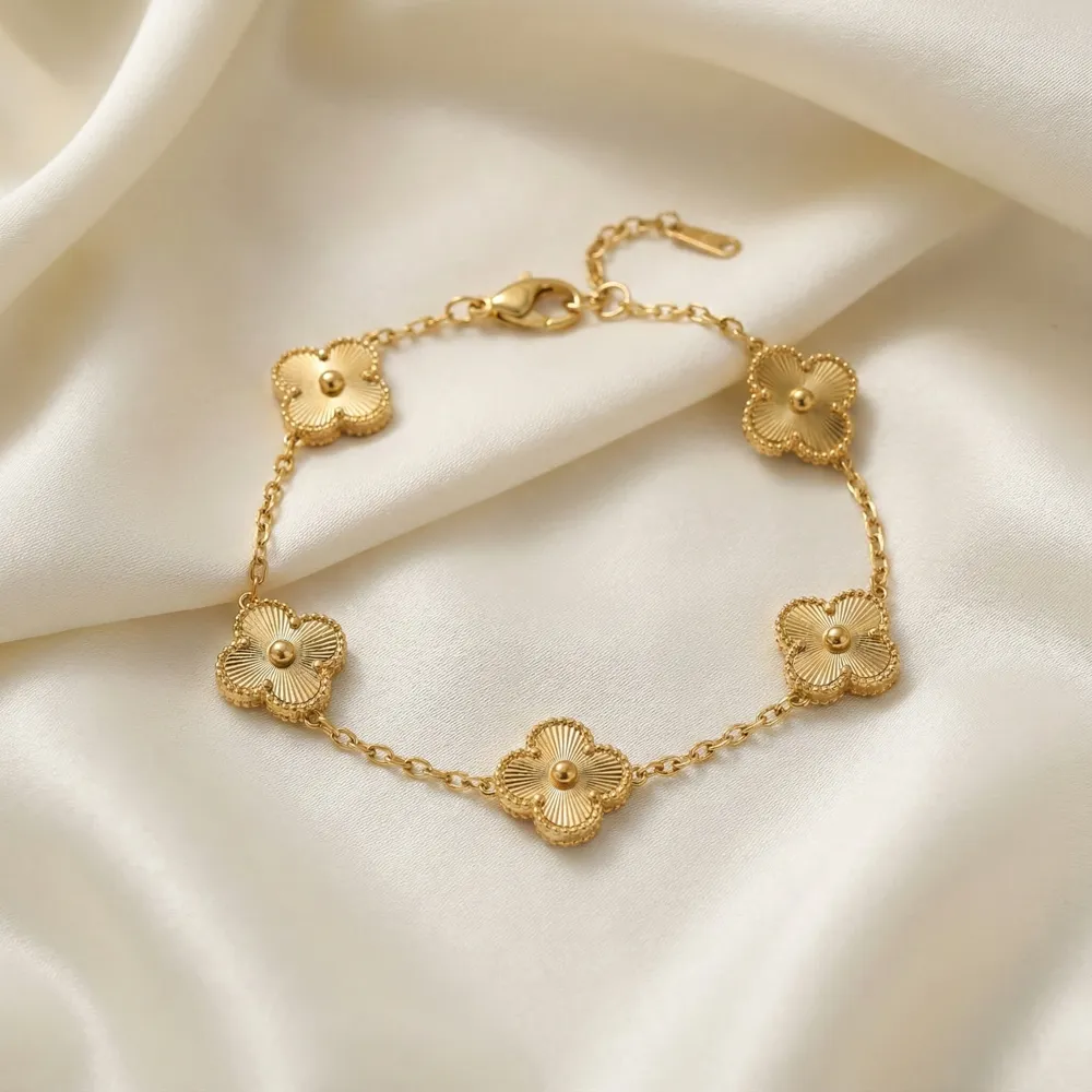 Golden Clover Charm Bracelet Placed on Fabric