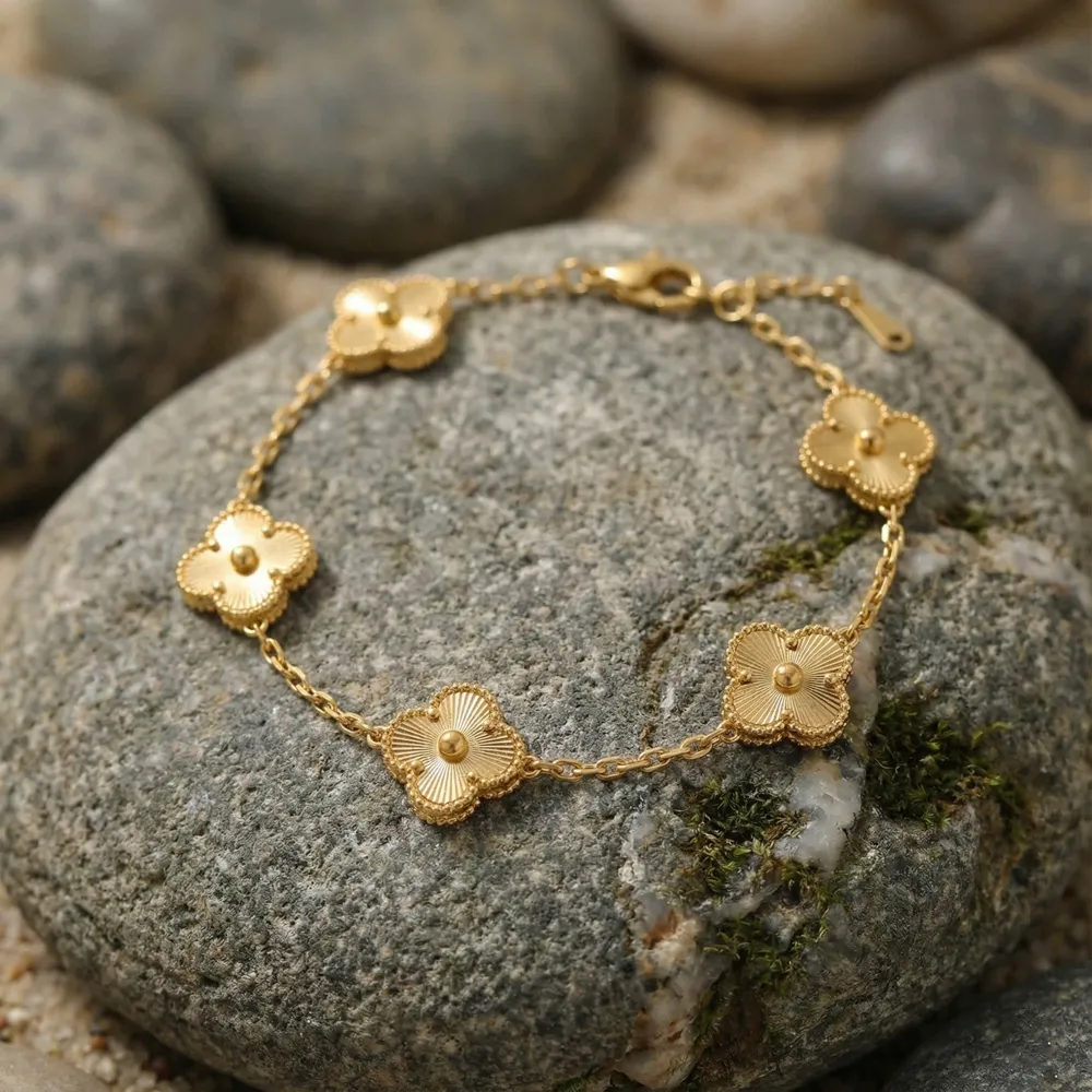 Golden Clover Charm Bracelet Placed on Stone