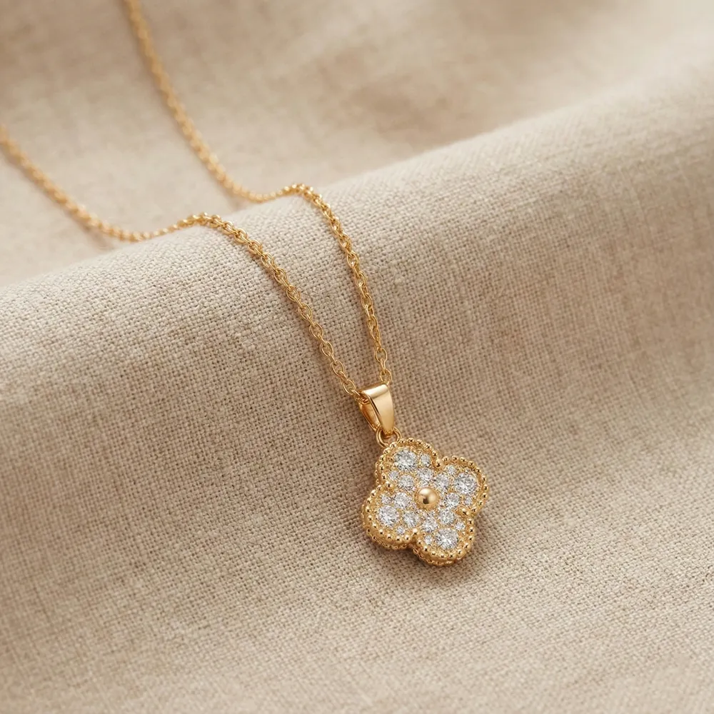 Golden Clover Shine Necklace Placed on Fabric