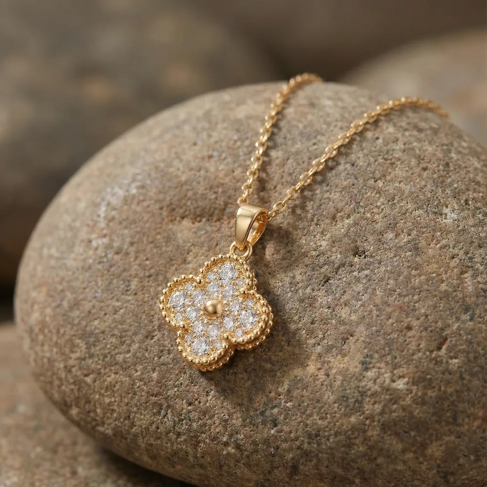 Golden Clover Shine Necklace Placed on Stone