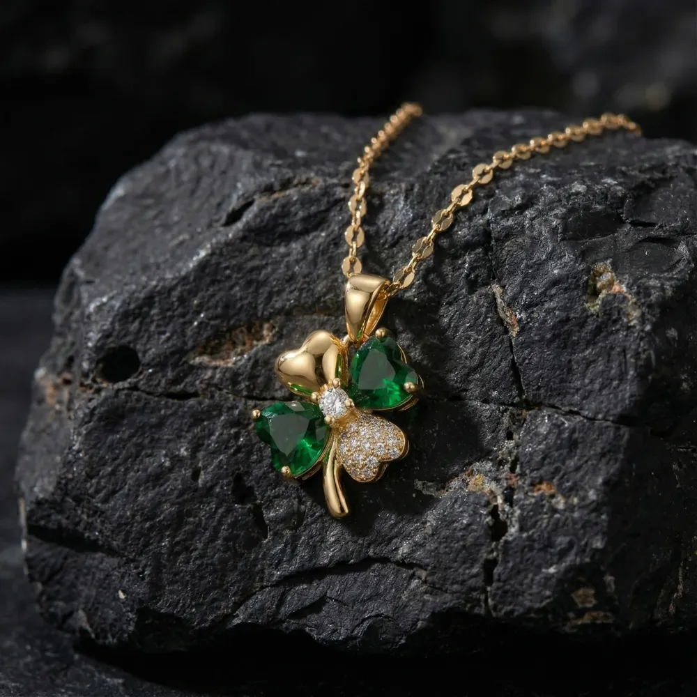 Golden Lucky Four Leaf Pendant Necklace Placed on Black Stone