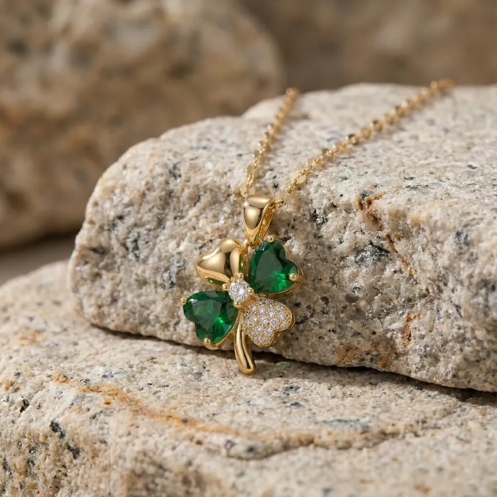 Golden Lucky Four Leaf Pendant Necklace Placed on Cream Stone