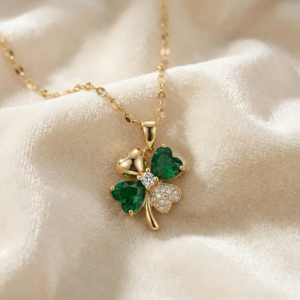 Golden Lucky Four Leaf Pendant Necklace Placed on Fabric