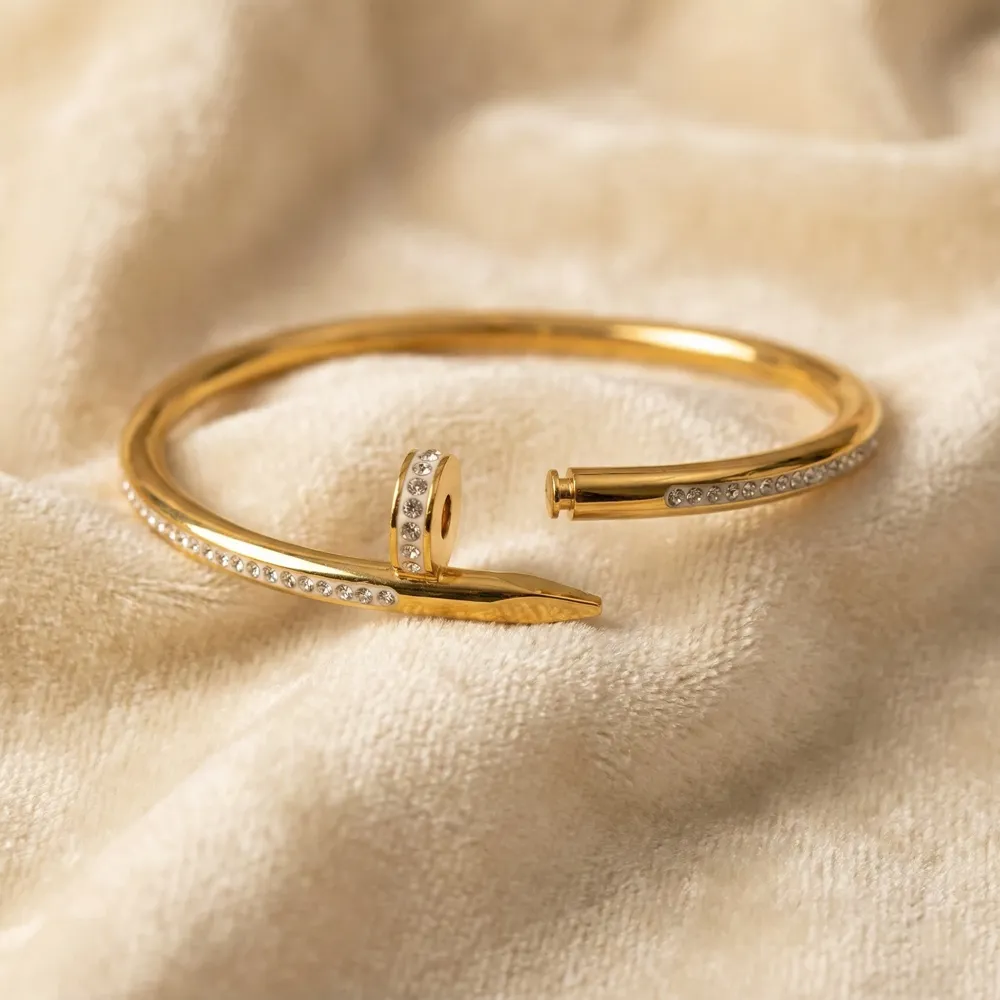 Golden Nail Diamond Studded Bracelet Opened and Placed on Fabric