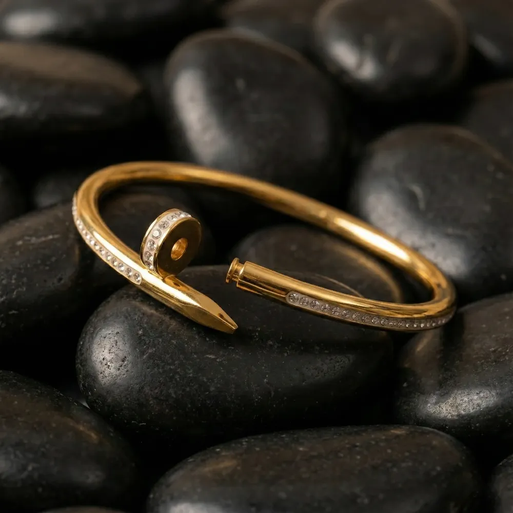 Golden Nail Diamond Studded Bracelet Placed on Black Stone