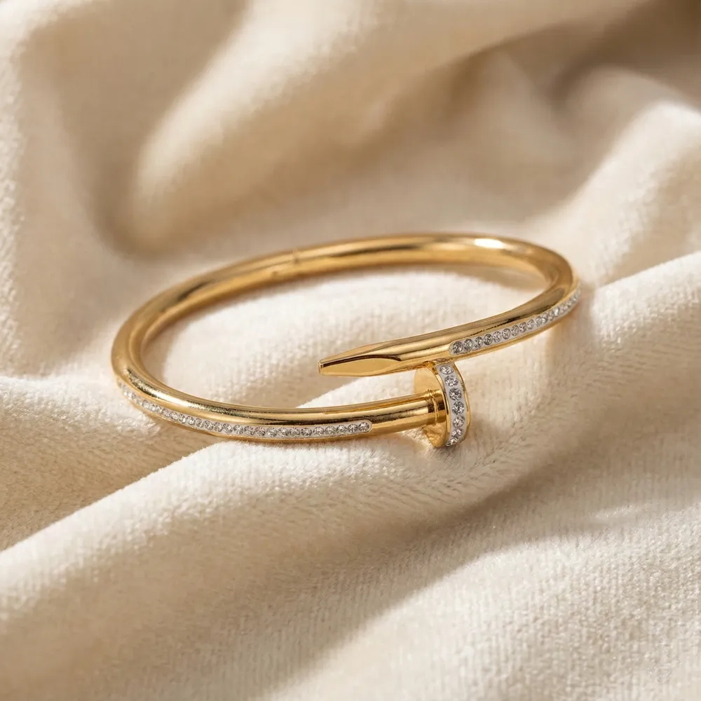 Golden Nail Diamond Studded Bracelet Placed on Fabric