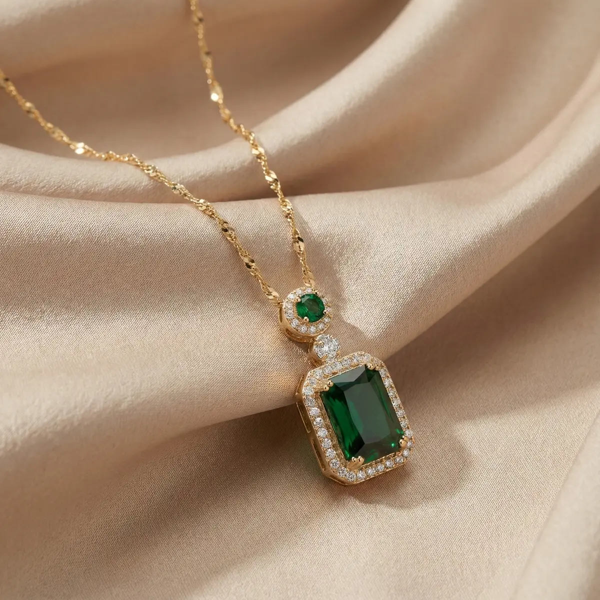 Royal Emerald Halo Pendant Necklace Placed on Fabric