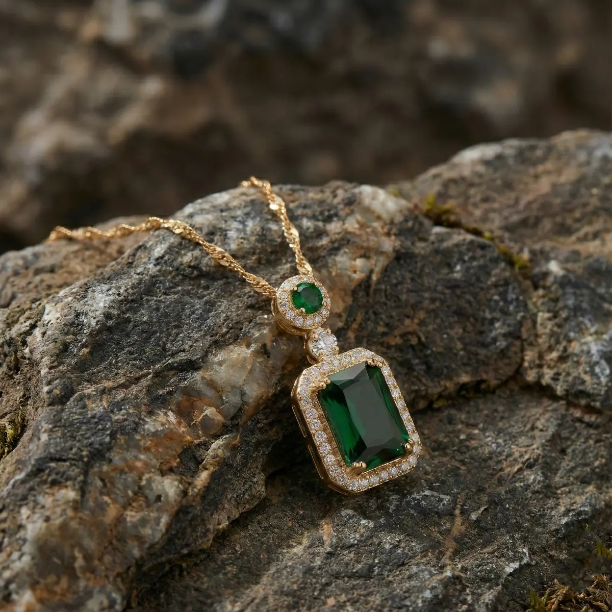 Royal Emerald Halo Pendant Necklace Placed on Stone